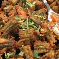 Bhindi Masala · Gluten free, vegan. Okra sautéed with fresh onions, tomatoes, and spices.