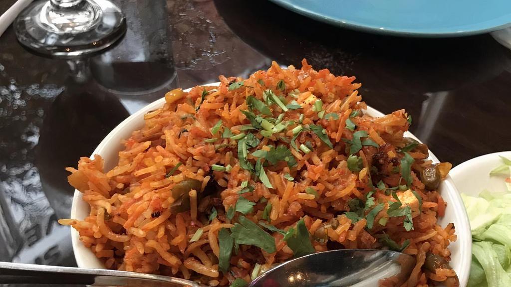 Vegetable Biryani · Gluten free. Vegetables cooked in aromatic saffron and herb infused basmati rice, with a side of mint raita.