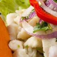Ceviche De Pescado · Pieces of white fish marinated with lemon and chilli served with sweet potatoes, yucca lettu...