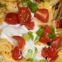 Messy Disco Fries · Fries with chilli, queso Macaroni, Sour cream, Jalepeno's, and chives