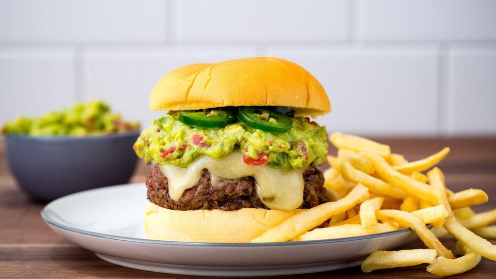 Pim Pam Mexican Burger · 8 oz organic Angus beef served with lettuce, tomatoes, onions & homemade pickles topped with guacamole, pickled jalapeno on Amy’s brioche bun or gluten free salt and pepper added to the burgers.