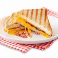 Piggy  · Grilled bacon and gooey American cheese on hearty white bread.