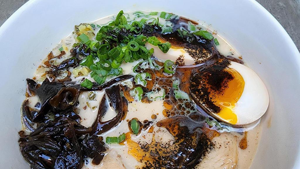 Tonkotsu Ramen · rich pork broth, shoyu-glazed chashu, woodear mushrooms, pickled mustard greens, soft egg, and mayu