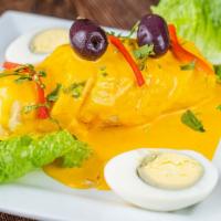 Papa A La Huancaina · Boiled potatoes with yellow pepper cheese sauce.