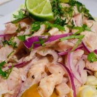 Ceviche De Pescado Y Papa A La Huancaina · Fish ceviche and potatoes with yellow pepper cheese sauce.