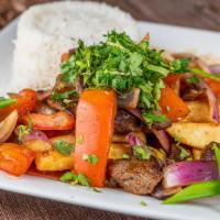 Lomo Saltado · Stir-fried onions and tomatoes. Served with rice and fries.