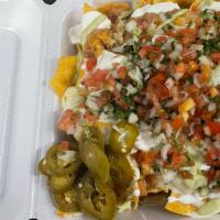 Ulitmate Nachos · Fried tortilla chips topped with your choice of protein, beans cheese , sour cream, jalapeño...