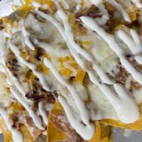 Nachos · Tortilla Chips topped with Beans, Cheese, Sour Cream and Chile Jalapeno.