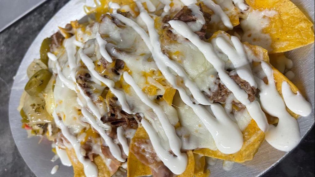 Nachos · Tortilla Chips topped with Beans, Cheese, Sour Cream and Chile Jalapeno.