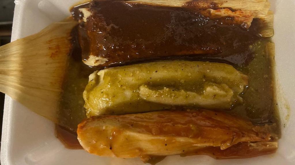 3 Corn Husk Tamales · 3 corn husk tamales with chicken and cheese with red green and mole sauce on top