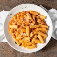 Vodka Rigatoni · Sautéed proscuitto and fresh tomatoes in a pink vodka sauce.