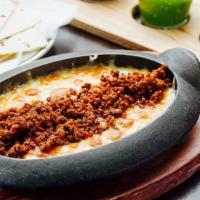 Queso Fundido · Mexican melted cheese (house blend); choice of homemade chorizo or mushrooms al epazote, cor...