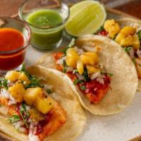 Tacos De Pescado Al Pastor (3 Pieces) · Gluten-free. Grilled fish of the day marinated in guajillo salsa, grilled pineapple, onion, ...