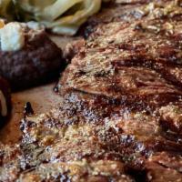 Carne Asada Plate · Grilled marinated skirt steak served with two enmoladas (mole dipped corn tortillas), black ...