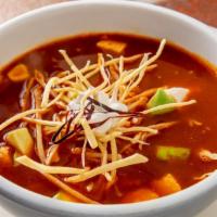 Sopa Azteca · Tortilla soup, organic chicken, chile guajillo, chile ancho, queso fresco, crema fresca, and...