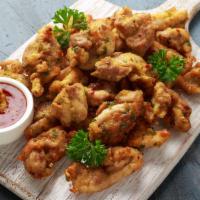 Fish Pakora · Fried crispy pieces of fish covered in mildly spiced chickpea batter.