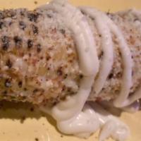 Elote · Mexican style corn on the cob, cotija cheese, chili & lime, crema