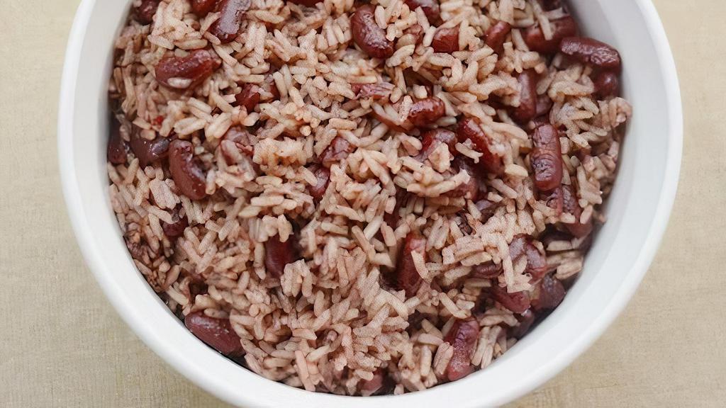 Rice & Peas · Jamaican Rice and Peas is infused with coconut,  herbs spices and cook until tender and delicious.