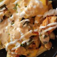 Cheesy Mexi Fries · Cheese sauce, chipotle sauce, sour cream, onion, cilantro and pickled jalapeños.