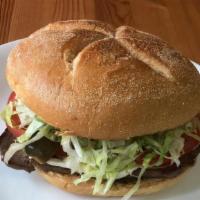 Torta · made with your choice of meat, Oaxaca cheese, refried beans, avocado, tomatoes, jalapeños, o...