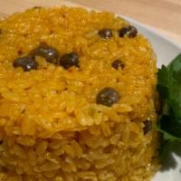 Arroz Con Gandules · Yellow rice and pigeon peas.