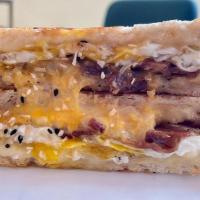 The Breakfast · Maple sea salt butter, cheddar, American, fried egg, bacon, everything bagel sprinkles on wh...