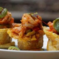 Tostones Rellenos · Green plantains stuffed shrimp and sofrito sauce.