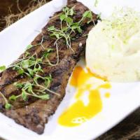 Churrasco · Grilled skirt steak, chimichurri, served with rice and beans.