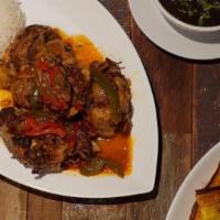 Rabo Encendido · Braised Oxtail in tomato red wine sauce, peppers, onions, cilantro, served with rice and beans