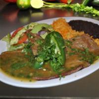 Bistec A La Cilantro · Spicy. Sautéed steak in our fresh homemade cilantro sauce, served with salad, rice, and beans.