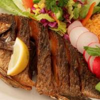 Fried Tilapia · Deep fried tilapia served with rice, beans and a fresh salad.