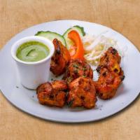 Chicken Triumph · 6 pieces. Chicken pieces marinated with spices and yogurt and grilled in an Indian clay oven.
