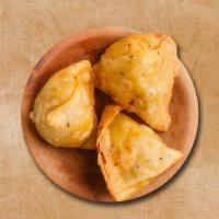Downtown Samosa · 2 pieces. Fried pastry with an amazing filling of spiced potatoes and peas.