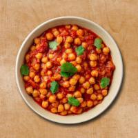Courtyard Chickpea Masala · Chickpeas cooked in an exotic blend of thick tomato puree and, Indian spices and herbs, topp...