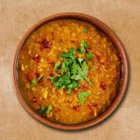 Yellow Light Lentil · Delightful yellow lentil slow-cooked with chopped onions and tomatoes, tempered with dry spi...