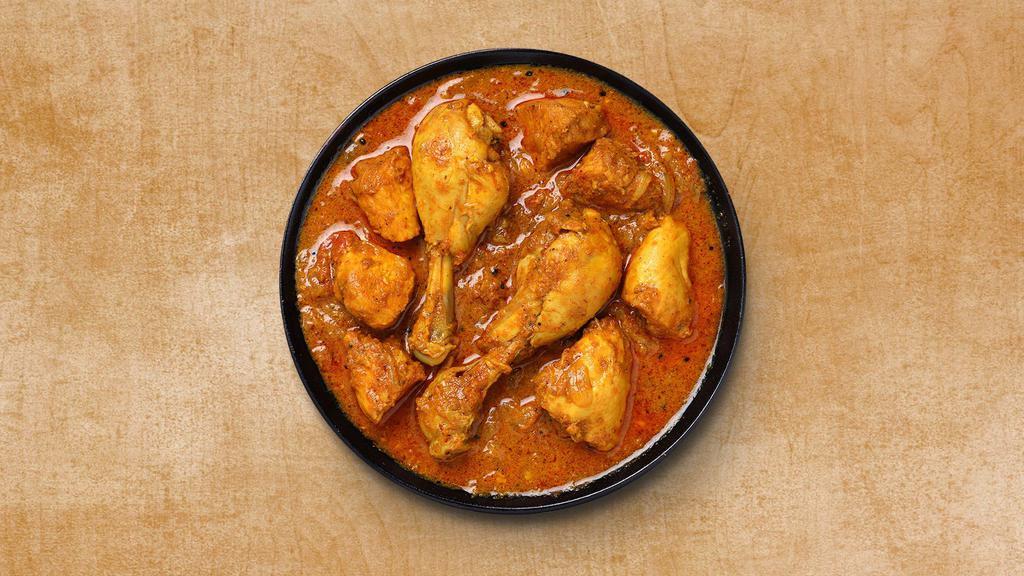 Classic Chicken Curry · A curry dish that consists of chicken stewed in an onion and tomato-based sauce, flavored with ginger, garlic, tomato puree, chili peppers and a variety of spices, including turmeric, cinnamon, cumin and cardamom, topped with cilantro.