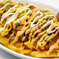Kimchi Fries · Topped with stir fried kimchi and bacon.