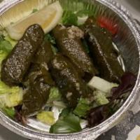Stuffed Grape Leaves · Grapes leaves stuffed with rice, pine nuts, raisins and cooked with extra virgin olive oil.