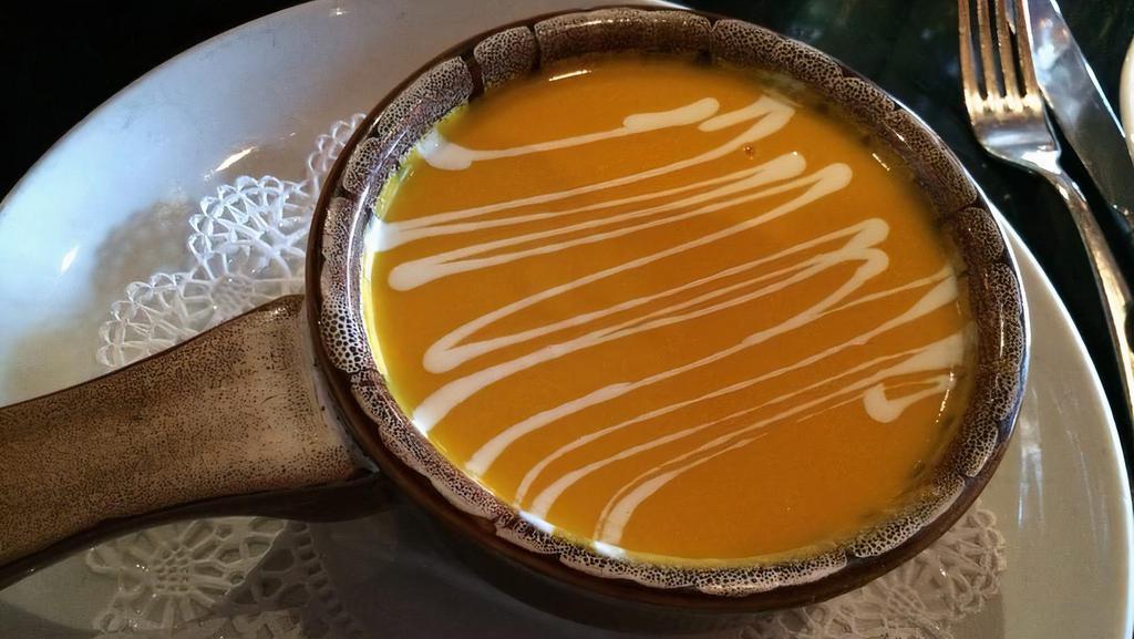 Carrot & Ginger Soup · Drizzled with crème traîche.