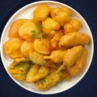 Pakora Mix Potion · Assorted vegetables dipped in a light batter and fried until golden brown.