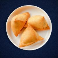 Veggie Sultry Samosa · Assorted vegetables mixed in a curry marinate & fried in a crispy wheat layer. Served with t...