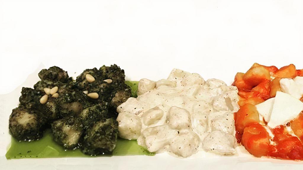 Gnocchi Tricolore · A potato sampler gnocchi, pesto sauce, cacio e pepe, tomato and mozzarella.