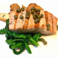 Salmon Piccata · Filet of Salmon with capers in a lemon and butter sauce, served with roasted potatoes and ga...