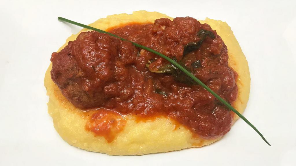 Polpette Alla Barese · Small veal meatballs in tomato sauce with over polenta.