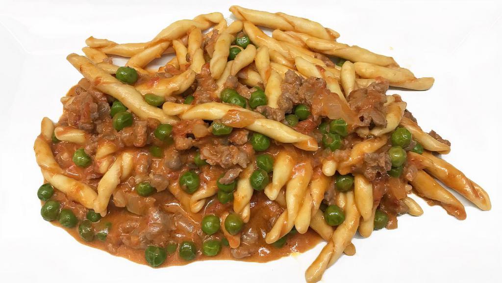 Fusilli Alla Buttera · Fresh fusilli pasta with sweet and hot sausages, sweet peas in a light cream and tomato sauce.