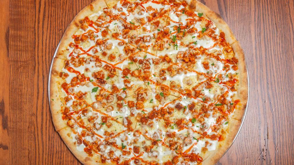 Buffalo Chicken Pizza · Tender chicken pieces marinated in a homemade buffalo sauce, spread out over blue cheese.