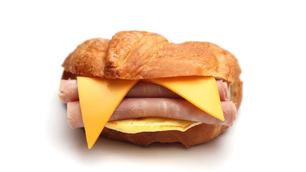 Croissant With Ham, Egg, And Cheese · Buttery and flakey croissant filled with fresh eggs, juicy ham, and melted cheese.