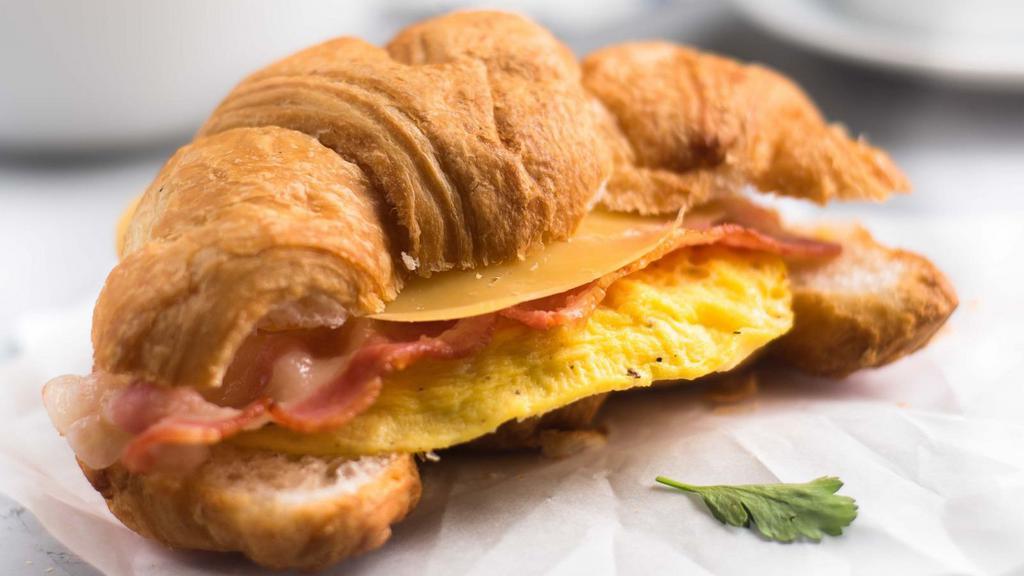 Croissant With Bacon, Egg, And Cheese · Buttery and flakey croissant filled with fresh eggs, crispy bacon, and melted cheese.