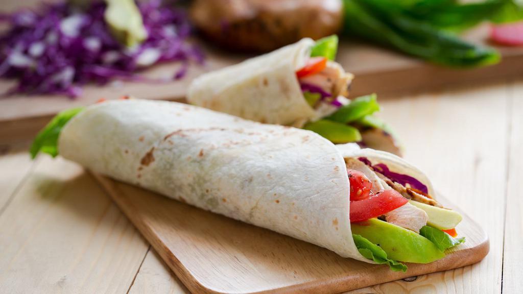 California Turkey Wrap · Delicious Wrap made with Sliced grilled turkey, avocado, plum tomato, romaine lettuce and cilantro with sour cream served on a wheat wrap.