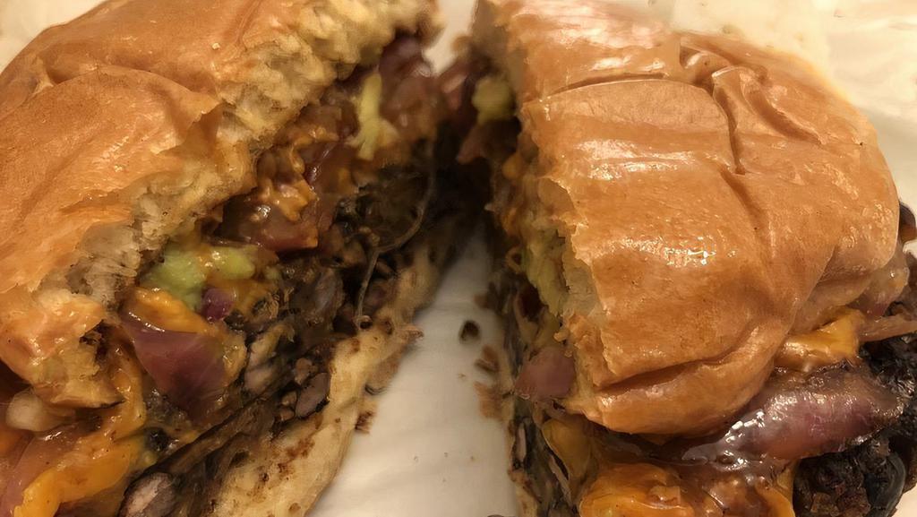 New Black Bean Burger · Homemade patty pressed with black beans, onion, parsley, garlic, green pepper, bread crumb, lime rind, spices and olive oil served on a brioche bun with avocado BBQ sauce, sautéed onions and cheddar.